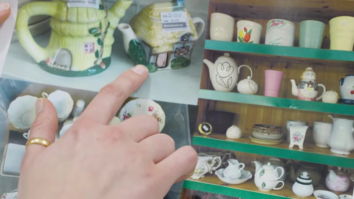 Collection of mismatched teacups and teapots from charity shops