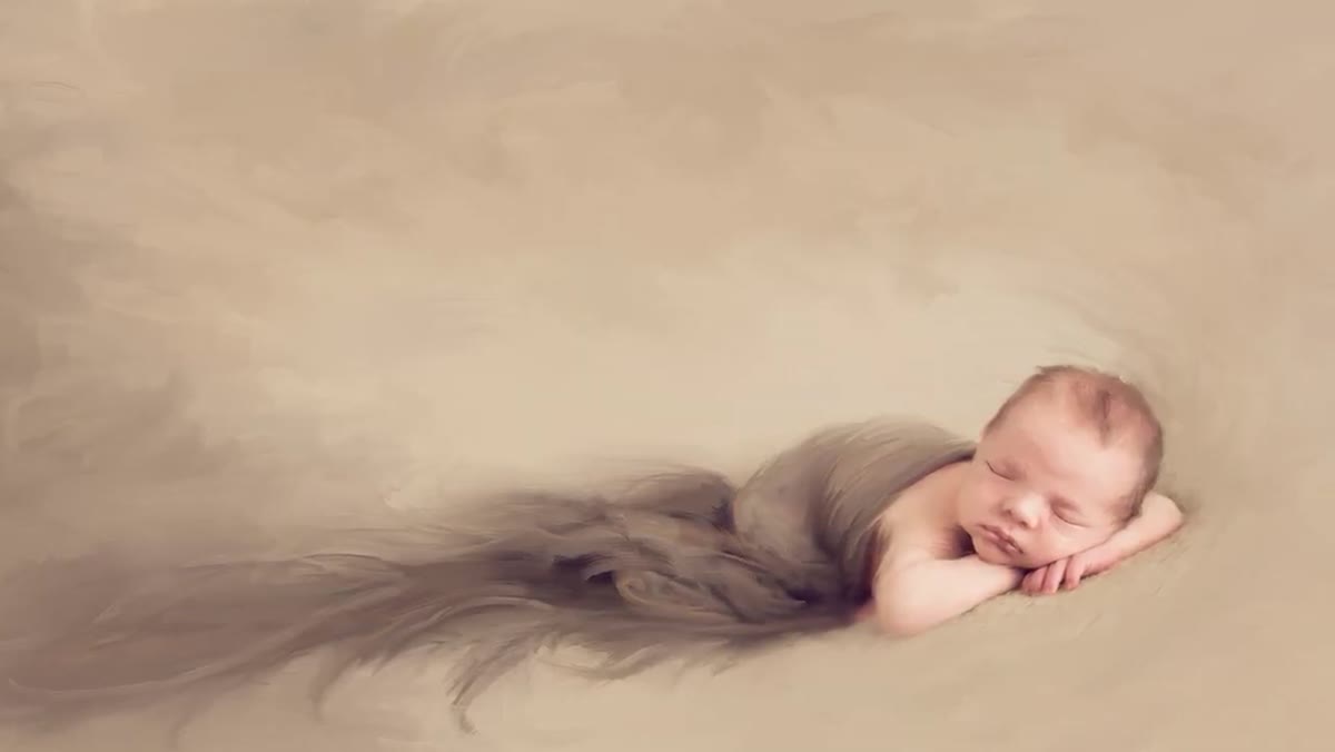 Photographer evaluating alert newborn before starting pose