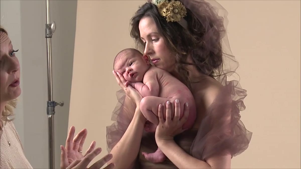 Photographer adjusting pose incrementally with baby still awake