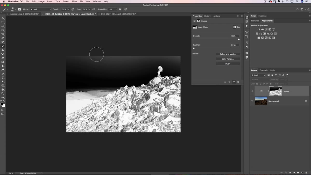 Black brush being painted over sky area on the layer mask